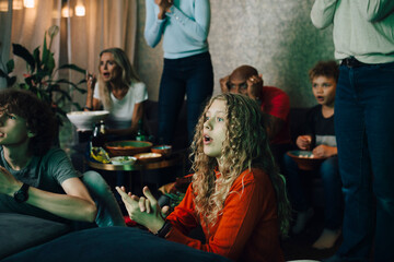 Disappointed family watching sports on TV at night