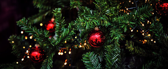 Magical Christmas - x-mas tree close-up, green pine branches with shiny, traditional red ornaments...