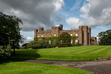 Fototapeta na wymiar Scone Palace, red sandstone brick castle in Perthshire, Scotland at nice sunny summer weather