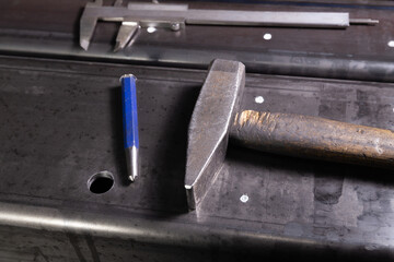 marking on a metal surface for drilling holes with a square and vernier calipers