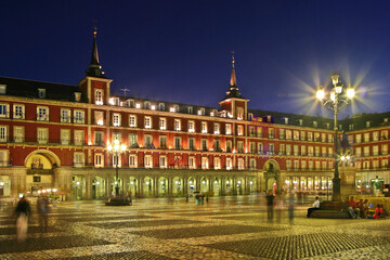 Fototapeta na wymiar Plaza Mayor at blue hour, surrounded by four-storey residential buildings