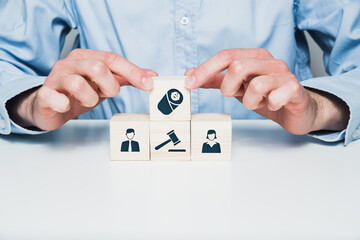 Man and wooden cubes with man, woman and child and court icons. Concept of divorce and childcare after divorce.
