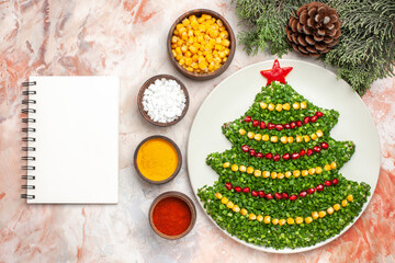 top view green salad in new year tree shape with seasonings on a light background salad meal color xmas photo