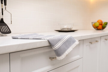 Fototapeta na wymiar Clean kitchen towel on counter at home, closeup
