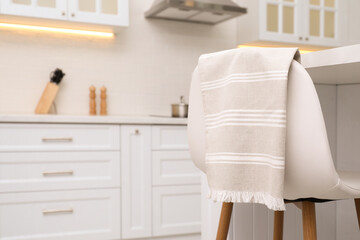 Clean kitchen towel on chair at home. Space for text
