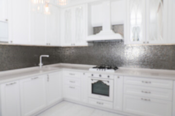 Fototapeta na wymiar Blurred view of beautiful kitchen interior with new stylish furniture