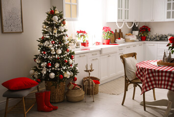 Beautiful kitchen interior with Christmas tree and festive decor
