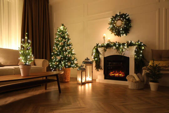 Beautiful room interior with fireplace and Christmas decor in evening