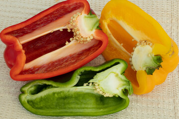 Topview of colorful chilies cut in half with showing seeds on white background