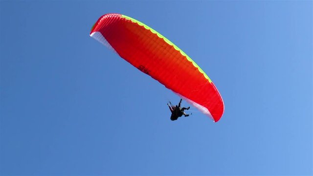 Paraglider flies by the Harder Kulm observation deck, Interlaken, Switzerland.