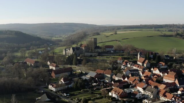 Drone aerial view of the fairytale castle Adelebsen on a beautiful autmn afternoon in golden sunlight. Adelebsen is a historic medieval town Flecken near G&ouml;ttingen in Niedersachsen, Germany.