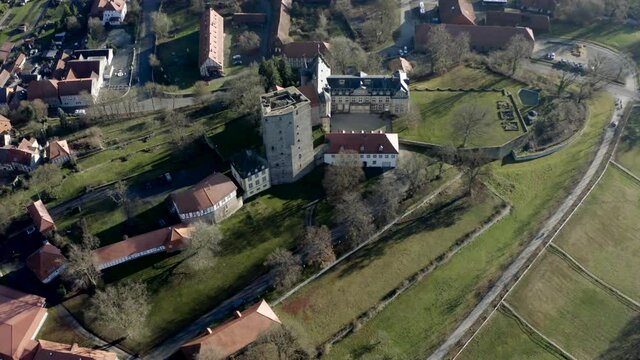 Drone aerial view of the fairytale castle Adelebsen on a beautiful autmn afternoon in golden sunlight. Adelebsen is a historic medieval town Flecken near G&ouml;ttingen in Niedersachsen, Germany.