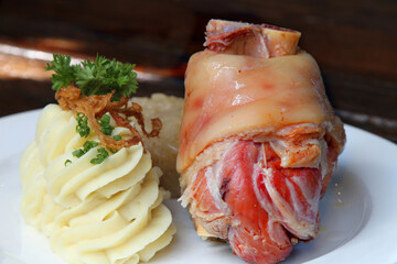 Eisbein, German pickled and cured ham hock served with potato mash and sauerkraut
