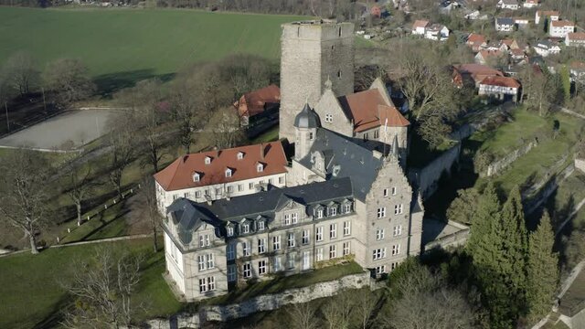 Drone aerial view of the fairytale castle Adelebsen on a beautiful autmn afternoon in golden sunlight. Adelebsen is a historic medieval town Flecken near G&ouml;ttingen in Niedersachsen, Germany.