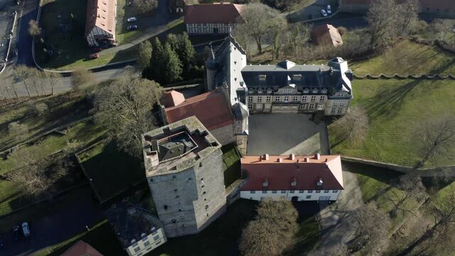 Drone aerial view of the fairytale castle Adelebsen on a beautiful autmn afternoon in golden sunlight. Adelebsen is a historic medieval town Flecken near G&ouml;ttingen in Niedersachsen, Germany.