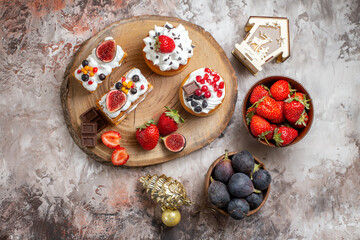 top view delicious cakes with fresh fruits on light background christmas cake dessert biscuit color