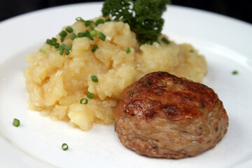Authentic German burger called Frikadelle served with potato salad