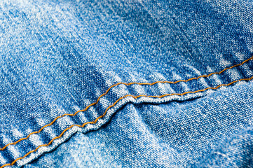 clothing items blue stonewashed faded jeans cotton fabric texture with seams, clasps, buttons and...