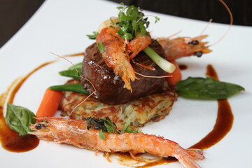 Surf and Turf, beef fillet steak with roesti, garden vegetables and prawns