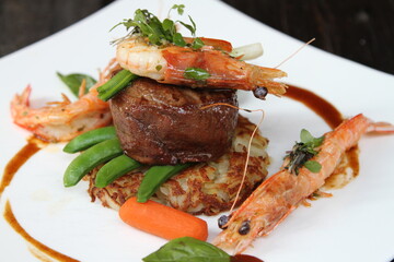 Surf and Turf, beef fillet steak with roesti, garden vegetables and prawns