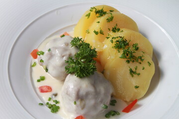 German meatballs Königsberger Klopse served with parsley potatoes