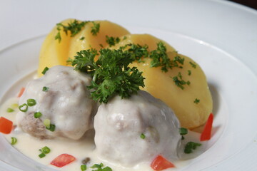 German meatballs Königsberger Klopse served with parsley potatoes