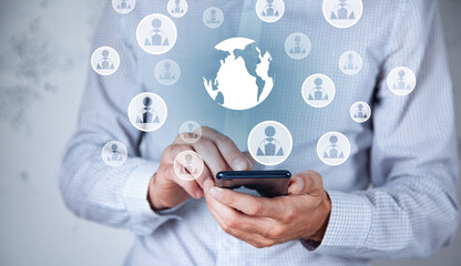 man using phone and global social network