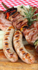 German mixed grill platter with sausages, pork chops, skewers, sauerkraut, asparagus, red cabbage, bread dumpling and wild garlic spätzle