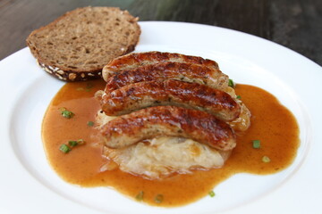 3 Nuremberg sausages on sauerkraut, served with sourdough bread and gravy
