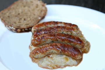 3 Nuremberg sausages on sauerkraut, served with sourdough bread and gravy