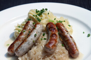 Nuremberg sausages on potato mash and sauerkraut
