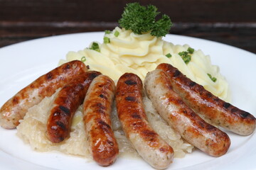 Nuremberg sausages on potato mash and sauerkraut