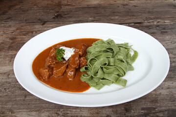 Veal goulash with spinach tagliatelle pasta
