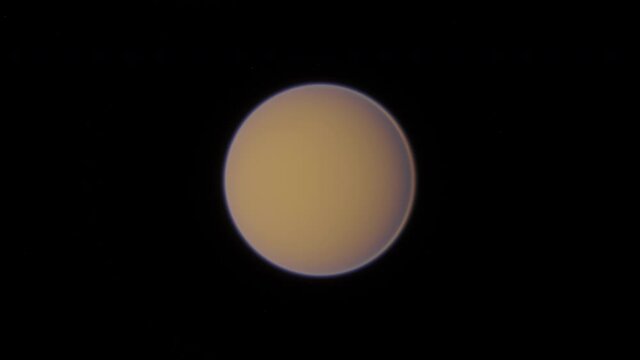 Orbiting Titan, the strange alien moon of the planet Saturn. The thick orange atmosphere seen from day and night sides, with Saturn and other moons visible in the background