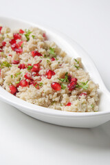 Couscous salad with pomegranate and  chopped parsley leaves