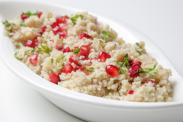 Couscous salad with pomegranate and  chopped parsley leaves