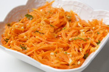 Simple carrot salad in a bowl, fresh and healthy vegetarian meal with parsley and garlic dressing