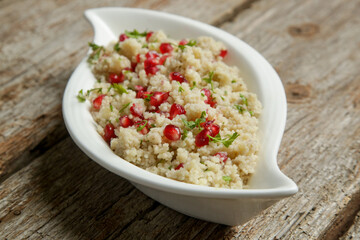 Couscous salad with pomegranate and  chopped parsley leaves