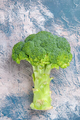 Vertical view of fresh vitamin bom green broccoli on gray background