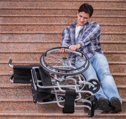 Disabled man on wheelchair having trouble with stairs