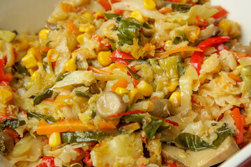 Mix of stewed vegetables in a bowl, close up
