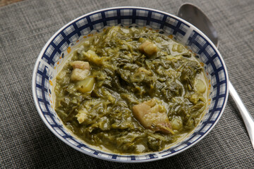Collard dish. Delicious homemade coolard stew served in in a bowl.