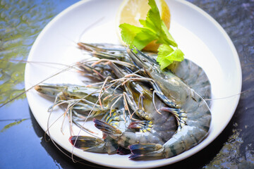 Raw shrimps prawns on white plate, Fresh Black Tiger Shrimp.