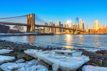 Brooklyn bridge East river and Manhattan at winter sunrise, New York City