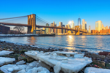 Brooklyn bridge East river and Manhattan at winter sunrise, New York City
