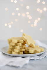 Shortbread in snowflake shapes and bokeh lights in the background