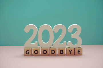Goodbye 2023 alphabet letter on blue and pink background