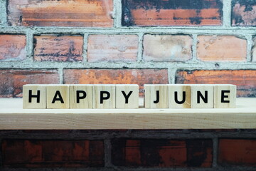 Happy June alphabet letter on shelves wooden background