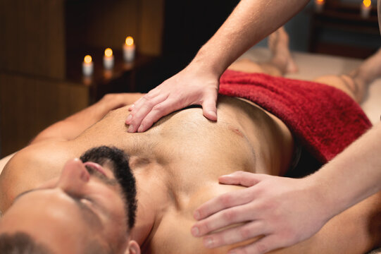 Close-up medical sports massage of the chest and pectoral muscles.