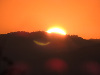 The sun sets the beautiful orange sky